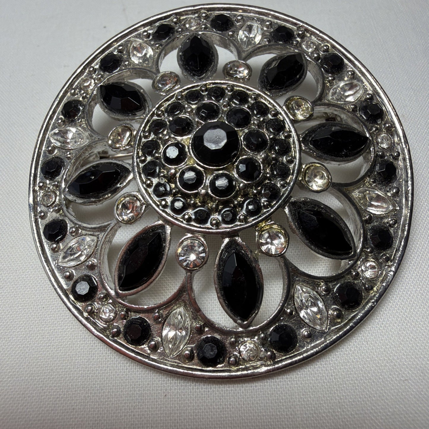 Vintage Brooch LC Black, Clear Gems Silver Tone Round Openwork 1980s Jewelry Pin